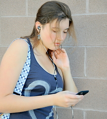 Image showing Female listening to music.