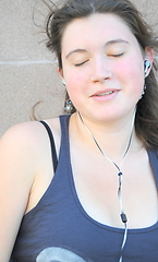 Image showing Female listening to music.