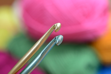 Image showing two crochet hooks on a colorful background