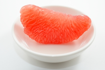 Image showing juicy red grapefruit slice on white