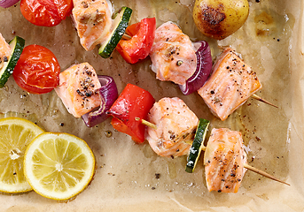 Image showing close up of roasted salmon and vegetable skewers