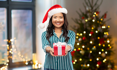 Image showing happy asian woman with christmas gift at home