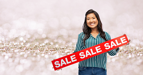 Image showing happy smiling young asian woman with sale banner