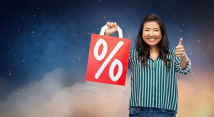 Image showing asian woman with percentage sign on shopping bags