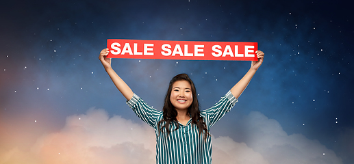 Image showing happy smiling young asian woman with sale banner