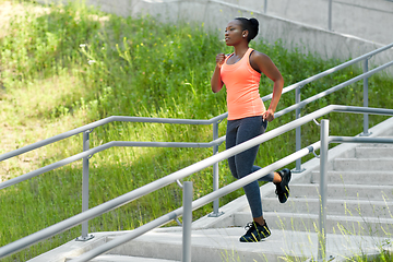 Image showing young african american woman running downstairs