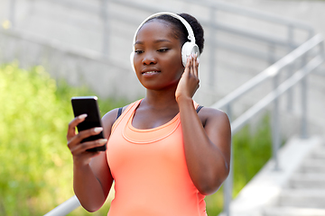 Image showing african american woman with headphones and phone