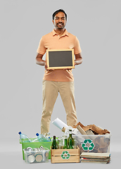 Image showing smiling man sorting paper, glass and plastic waste