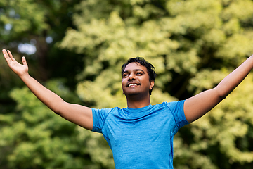 Image showing happy indian man doing yoga at summer park