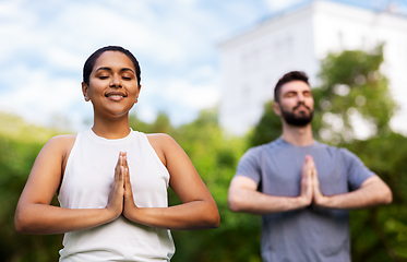 Image showing group of people doing yoga at summer park