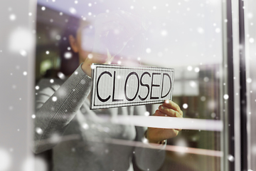 Image showing woman hanging banner with closed word on door