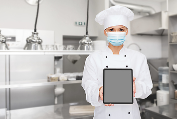 Image showing female chef in mask with tablet pc at kitchen
