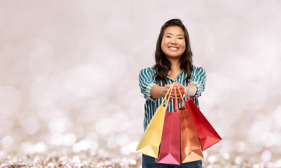 Image showing happy asian woman with shopping bags