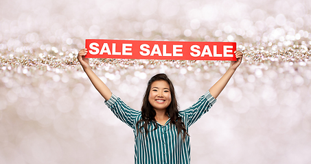 Image showing happy smiling young asian woman with sale banner