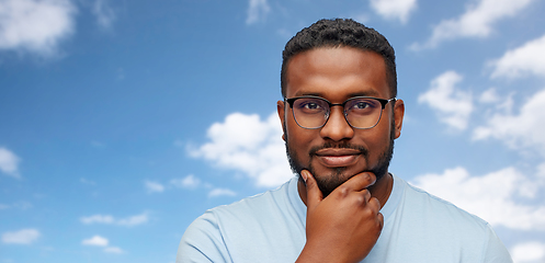 Image showing portrait of african american in glasses over sky