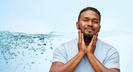 Image showing happy african american man touching his beard