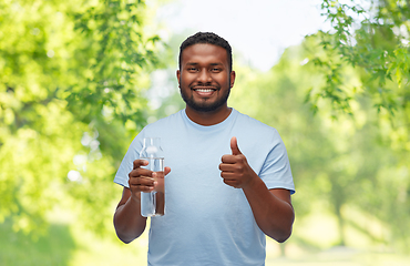 Image showing happy african man with water in glass bottle