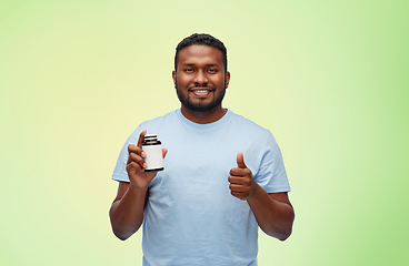 Image showing happy african man with medicine showing thumbs up