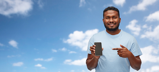Image showing african american man with smartphone over sky