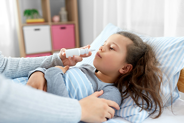 Image showing mother with nasal spray treats sick daughter