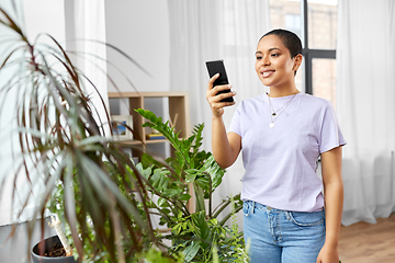 Image showing african american woman with smartphone at home