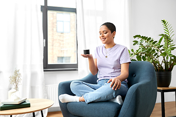 Image showing african american woman with smart speaker at home