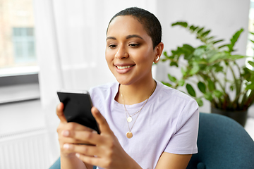 Image showing african american woman with smartphone at home