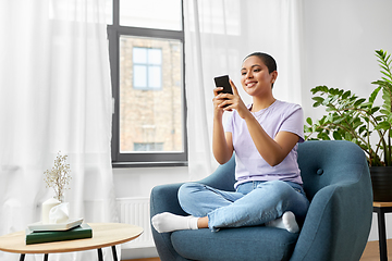 Image showing african american woman with smartphone at home