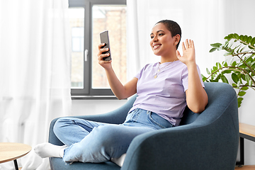 Image showing woman with smartphone having video call at home