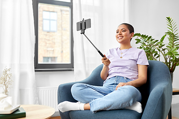 Image showing happy african american woman taking selfie at home