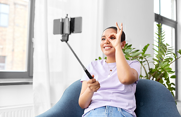 Image showing happy african american woman taking selfie at home