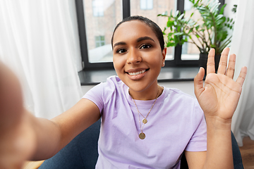 Image showing happy african american woman taking selfie at home