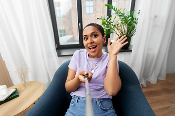 Image showing happy african american woman taking selfie at home