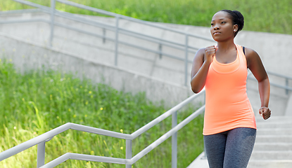 Image showing young african american woman running downstairs