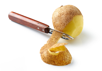 Image showing peeling potato