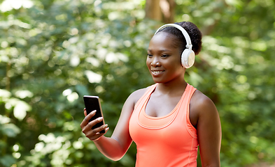 Image showing african american woman with headphones and phone