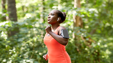 Image showing african american woman with earphones and phone