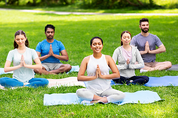 Image showing group of happy people doing yoga at summer park