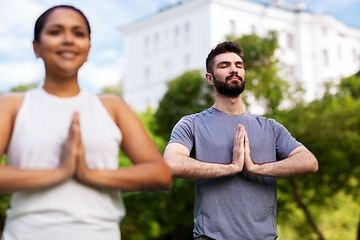 Image showing group of people doing yoga at summer park