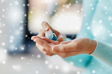 Image showing close up of woman spraying hand sanitizer