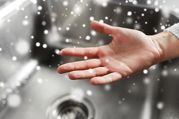 Image showing close up of clean woman's hand over kitchen sink