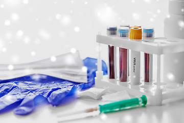 Image showing beakers with virus blood tests, syringe and gloves