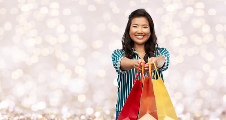 Image showing happy asian woman with shopping bags