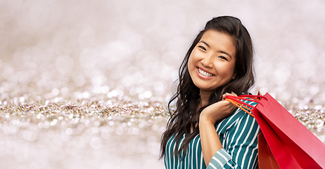 Image showing happy asian woman with shopping bags