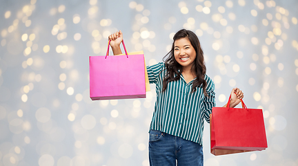 Image showing happy asian woman with shopping bags