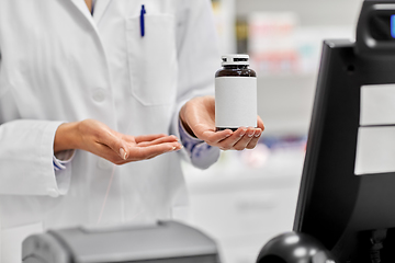 Image showing close up of pharmacist with medicine at pharmacy