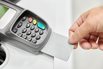 Image showing close up of hand with credit card in card-reader