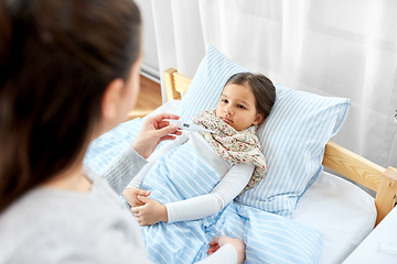 Image showing mother measuring temperature of sick daughter