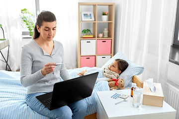 Image showing ill daughter and mother with laptop at home