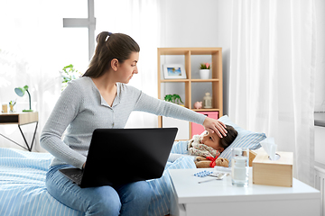 Image showing ill daughter and mother with laptop at home